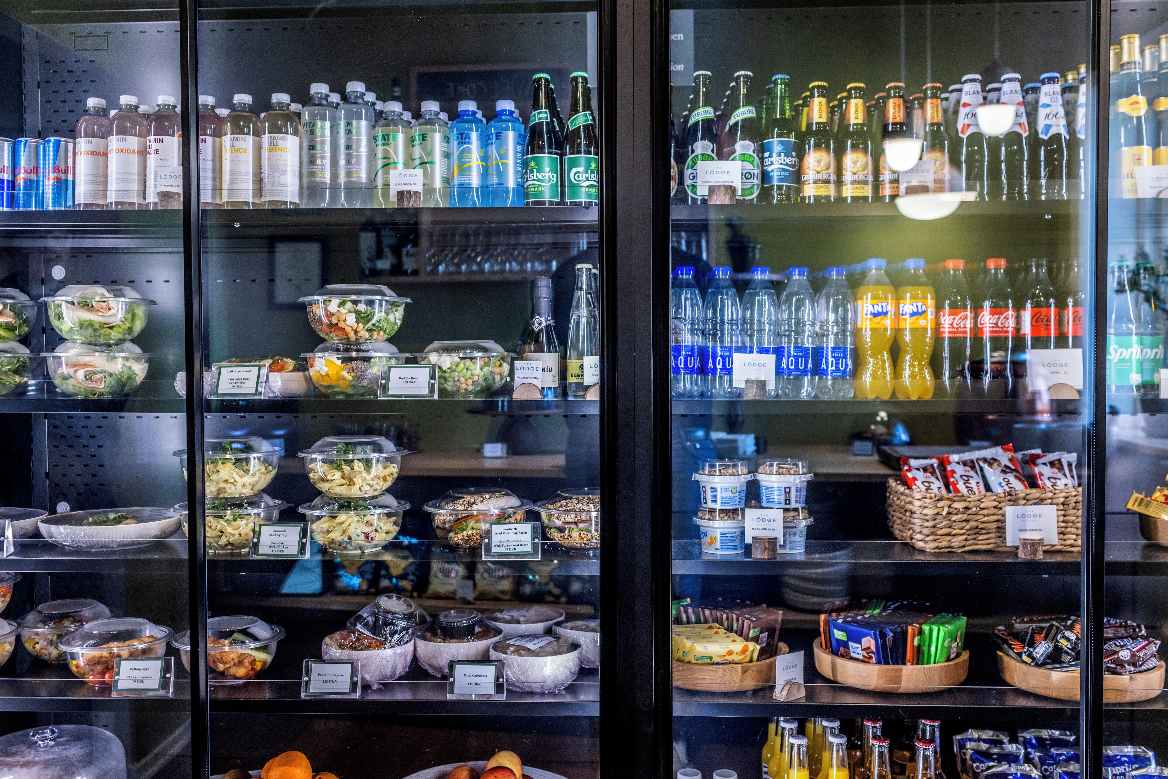 A refrigerated display case with various beverages and food items.