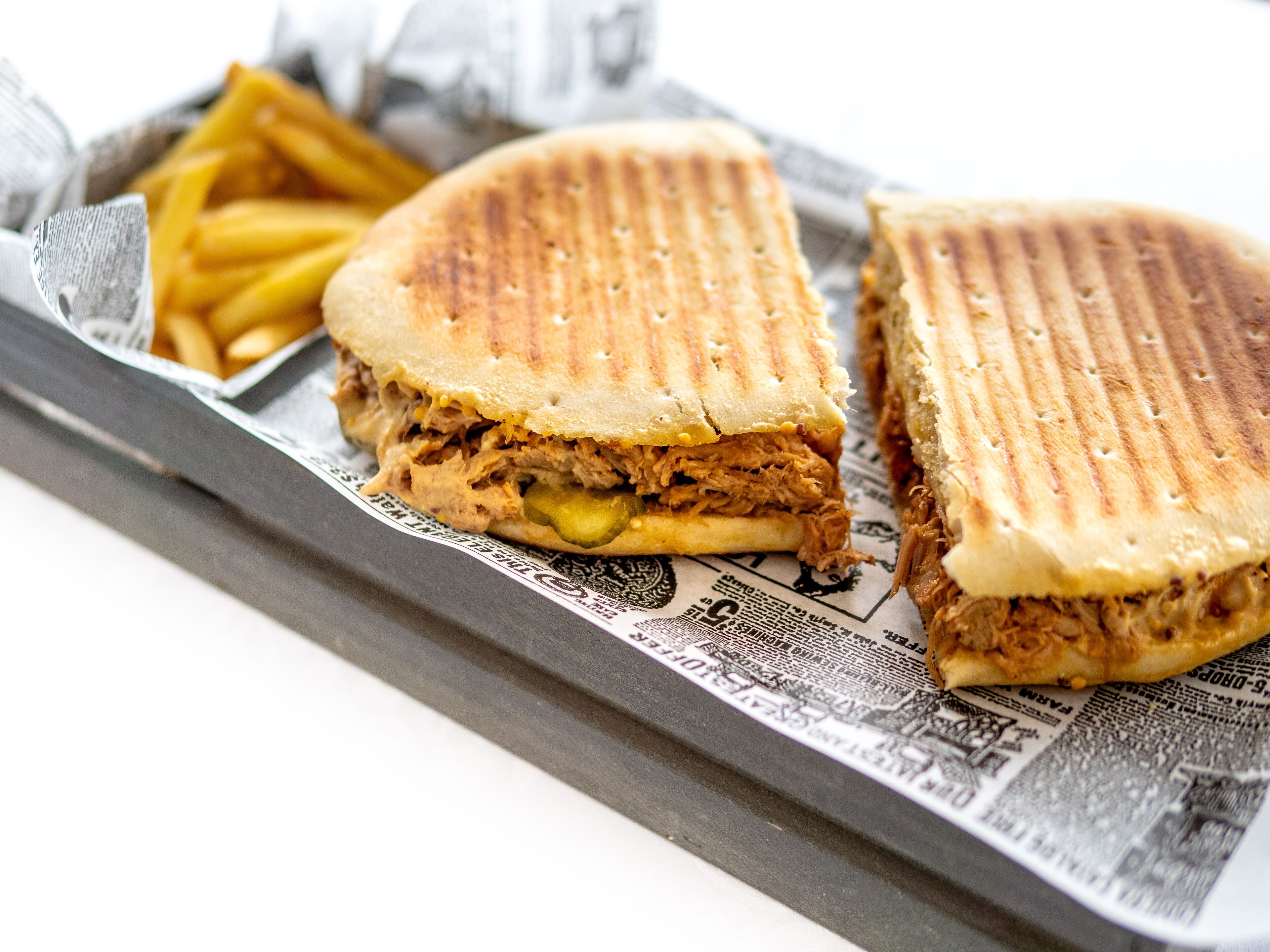 A sandwich with a side of fries on a tray.