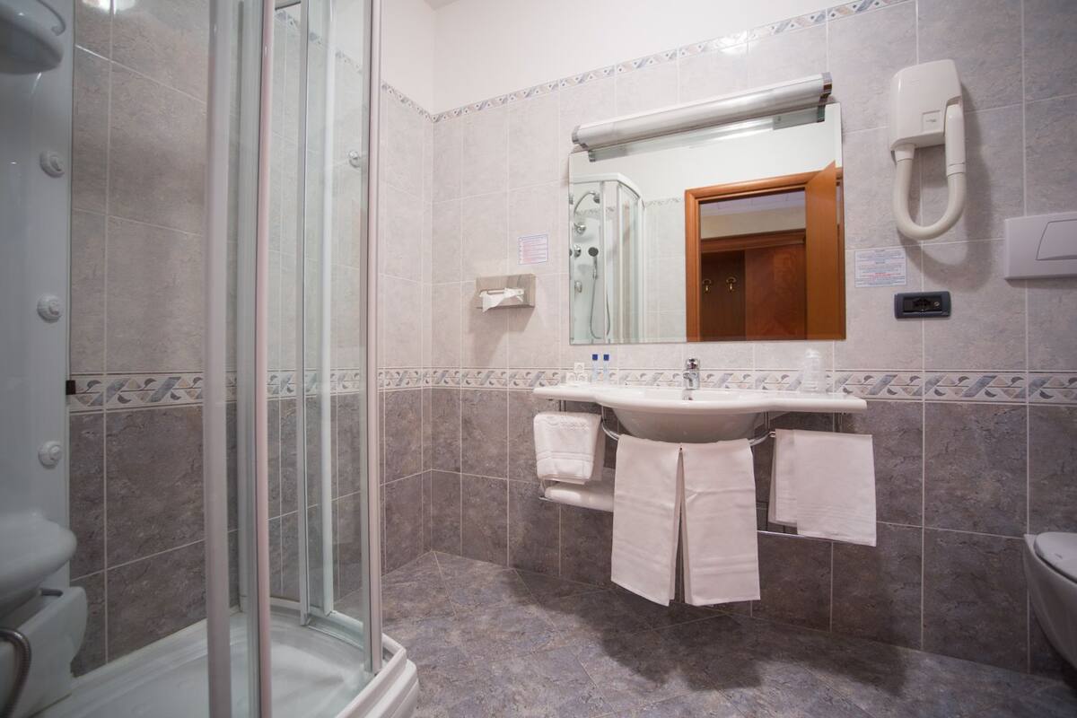 hair dryer, slippers, bidet, towels