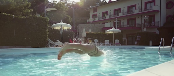 Seasonal outdoor pool, pool umbrellas, pool loungers