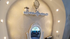 A vanity with a mirror, lights, and a hairdryer. - Tower Guest House (York)