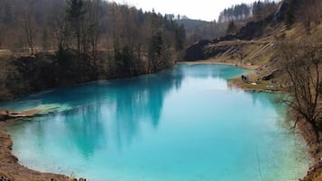 A serene lake surrounded by forested hills.