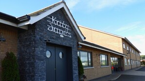 A building with a stone facade and a sign that reads "Katy's Diner". - Curran Court Hotel (Larne)