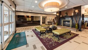A hotel lobby with a reception desk, seating area, and a fireplace. - Homewood Suites by Hilton Oxnard/Camarillo (Oxnard)