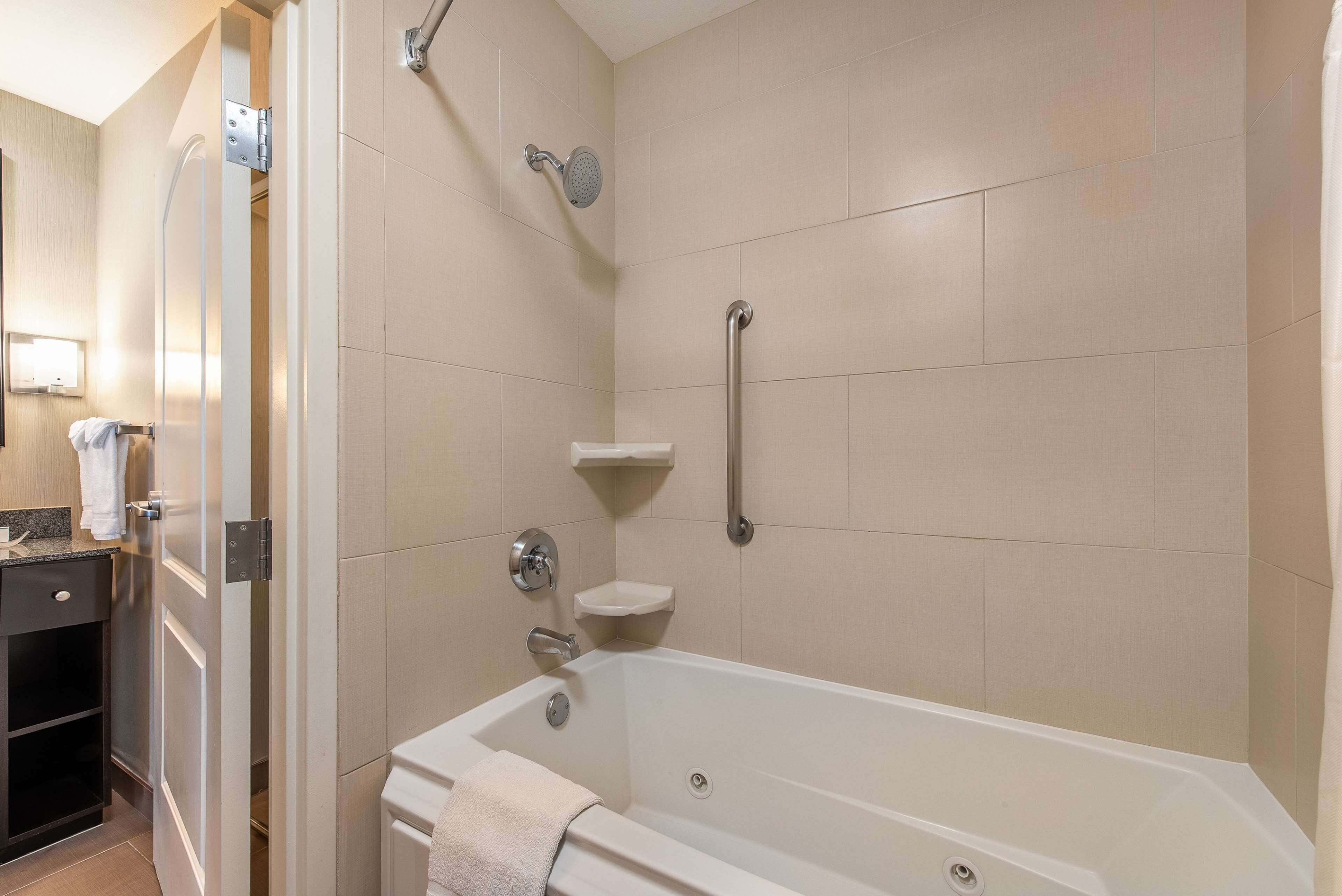 A modern bathroom with a bathtub, a shower, and a toilet.