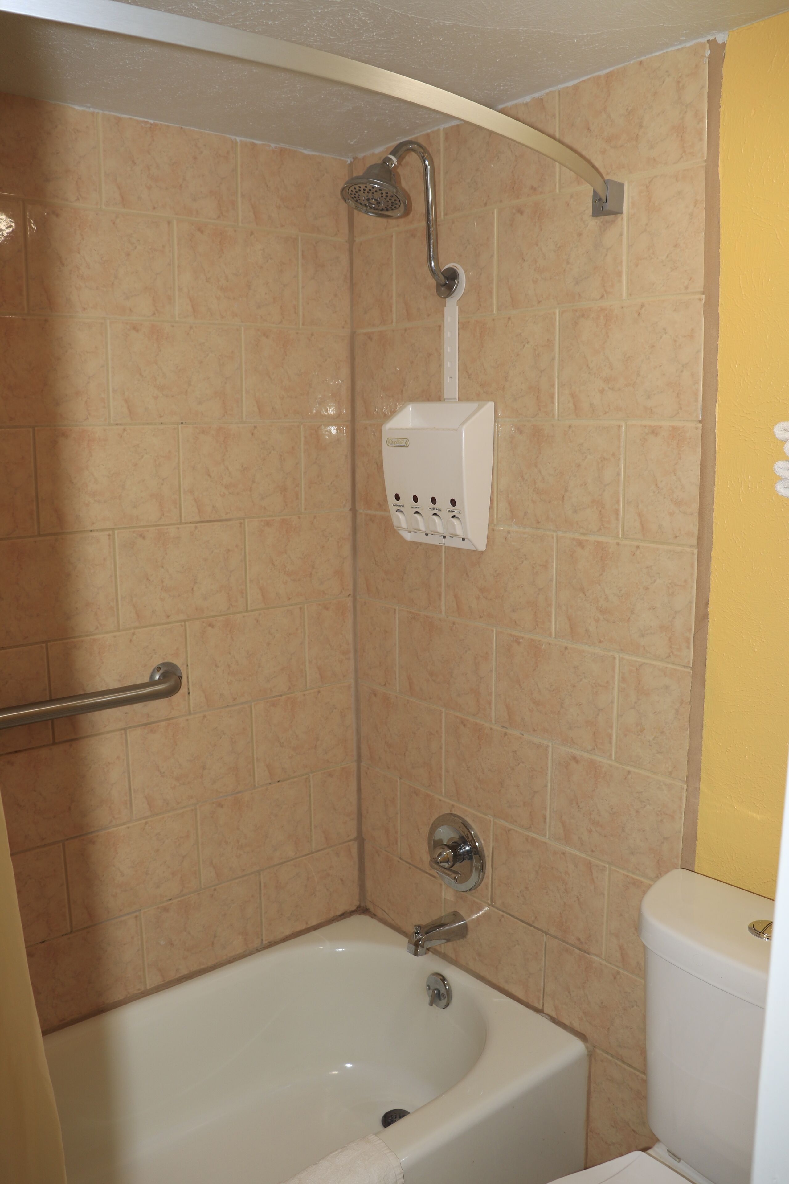 A bathroom with a bathtub, a shower, and a toilet.