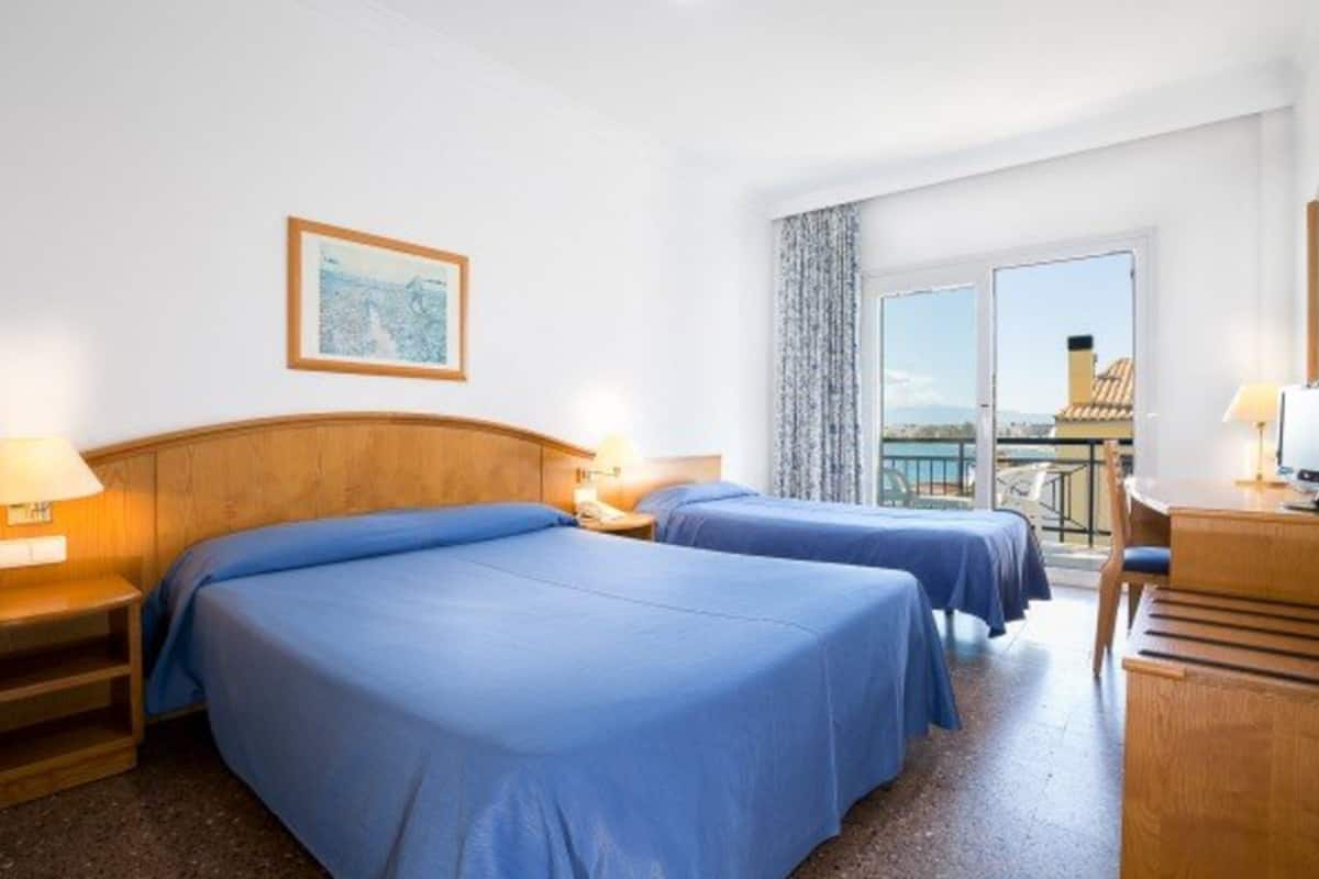 triple room, partial sea view | in-room safe, desk, free cots/infant beds, rollaway beds