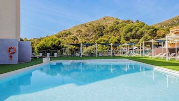 Seasonal outdoor pool, open 10:00 AM to 10:00 PM, pool umbrellas