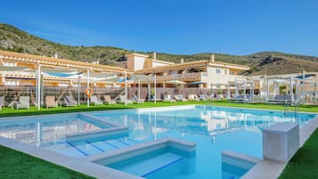 Seasonal outdoor pool, open 10:00 AM to 10:00 PM, pool umbrellas