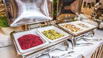 A buffet setup with multiple serving dishes containing various food items.