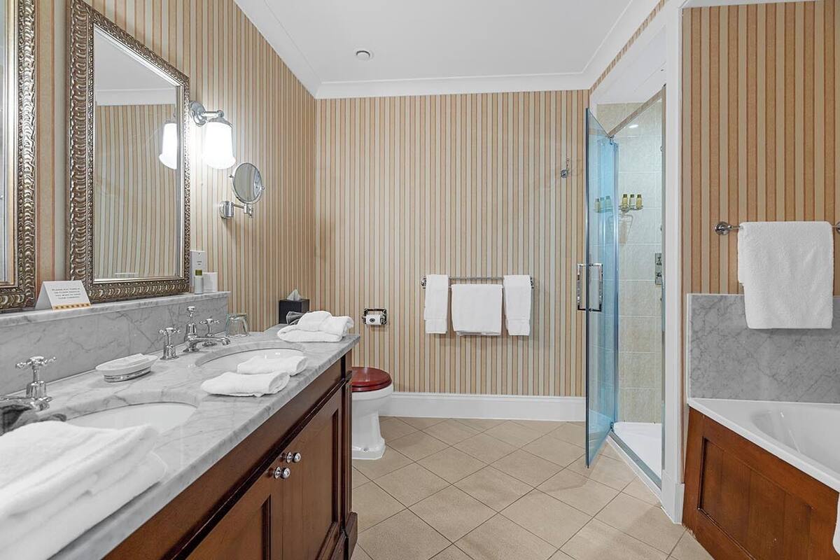 classic king room | bathroom | rainfall showerhead, free toiletries, hair dryer, bathrobes