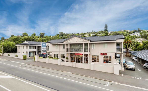 A hotel with a two-story structure, a balcony on the second floor, and a sign for 'Flames on 40' restaurant. - The Hotel Nelson (Nelson)