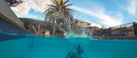 Outdoor pool, a heated pool, sun loungers