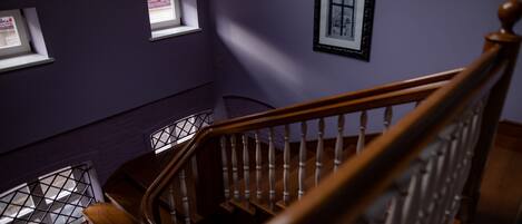 A staircase with wooden railings leading to a landing.