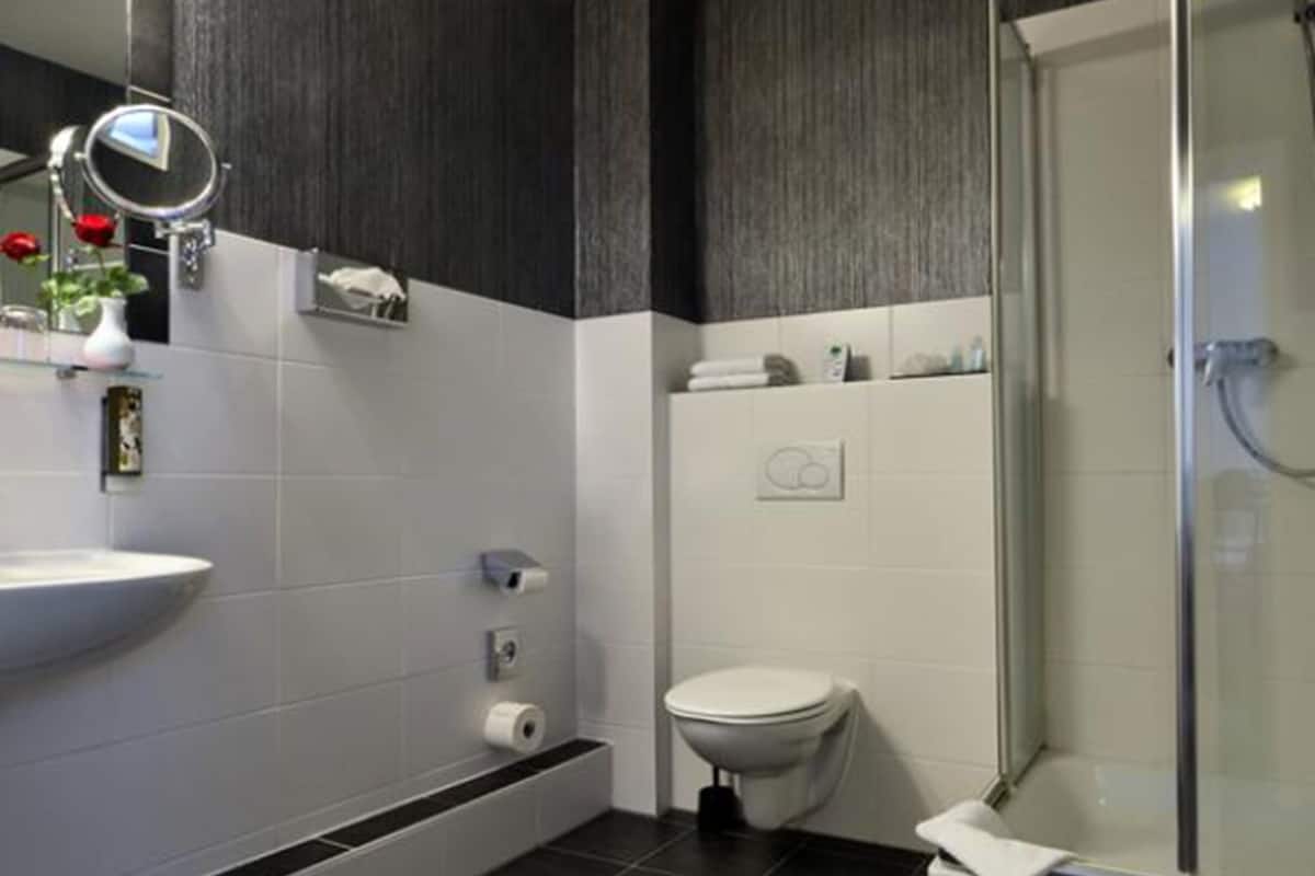 shower, hair dryer, slippers, towels