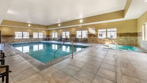 An indoor swimming pool with clear water, tiled floors, and sunlit windows. - Best Western Plus Grand Island Inn & Suites (Grand Island)