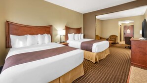 A hotel room with two beds, a desk, a chair, and a television. - Best Western Plus Grand Island Inn & Suites (Grand Island)