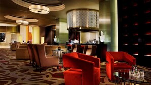 A hotel lobby with leather armchairs, a bar area, and a patterned carpet. - Kempinski Hotel Yinchuan (Yinchuan)