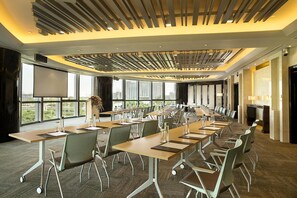 A conference room with multiple tables and chairs, large windows, and a modern ceiling design. - Kempinski Hotel Yinchuan (Yinchuan)