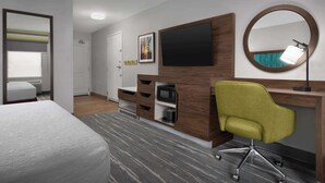 A hotel room with a bed, a desk with a chair, a TV, a mirror, and a microwave. - Hampton Inn Yorkville (Yorkville)