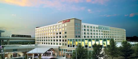 A Marriott hotel with a modern design, a covered entrance, and a landscaped area in front.