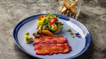 A plate with food, a glass, and a textured surface.