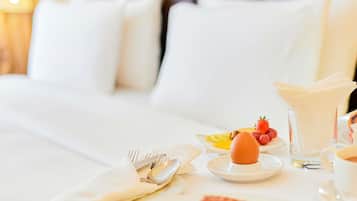 A neatly arranged breakfast table with plates, cutlery, and a glass of water.