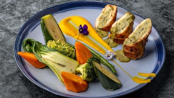 A plate with various vegetables and a piece of meat.