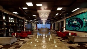 A hotel lobby with a checkered floor, red seating, a chandelier, and a large wall mural. - Hilton Garden Inn Kutahya (Kutahya)