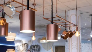 A variety of pendant lights and lampshades in a store.