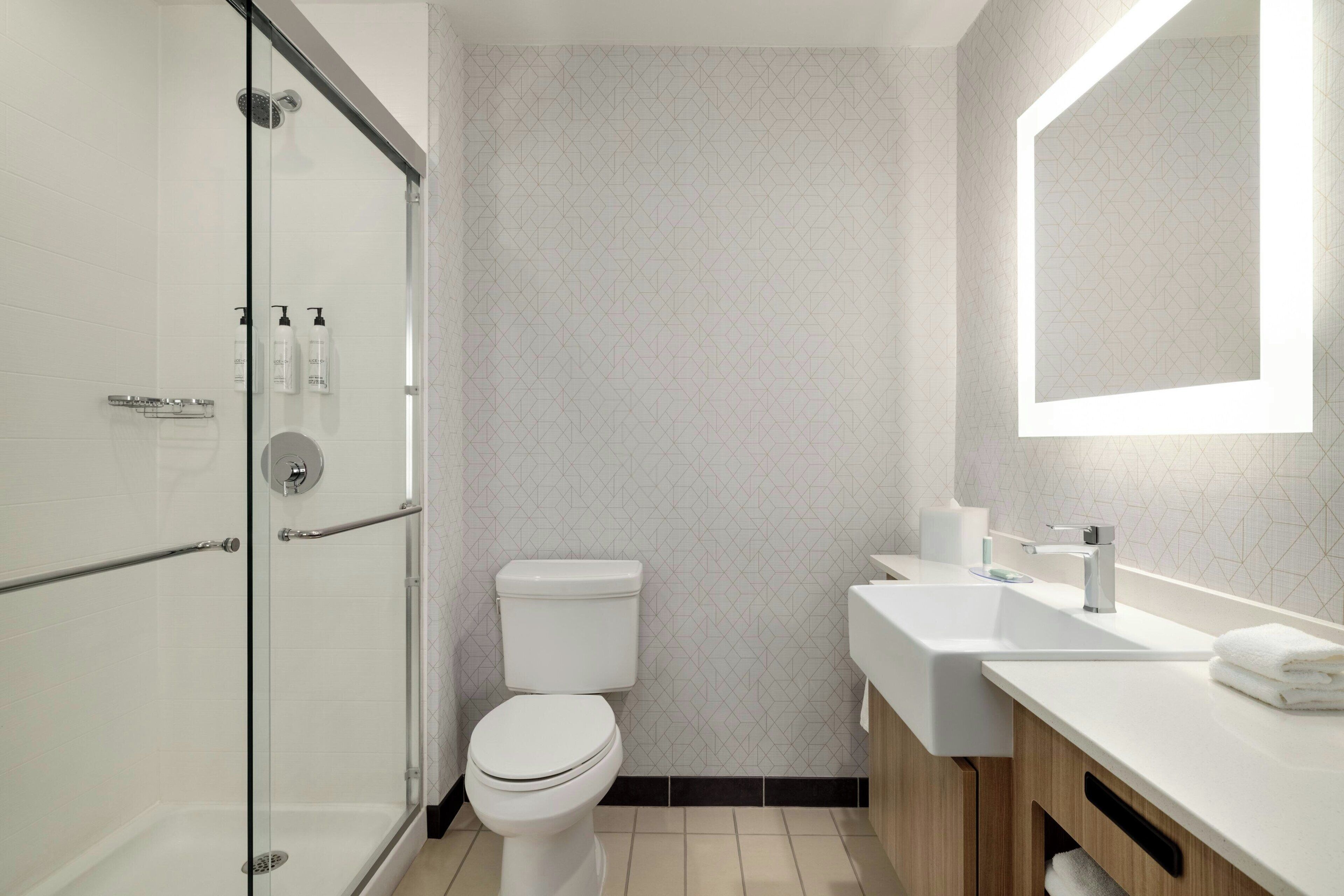 designer toiletries, hair dryer, towels