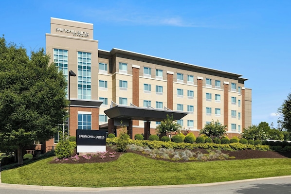 A modern hotel building with a sign reading "Springhill Suites by Marriott."