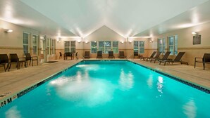 An indoor swimming pool with clear blue water, surrounded by lounge chairs and a tiled floor. - Residence Inn Bridgewater Branchburg (Branchburg)