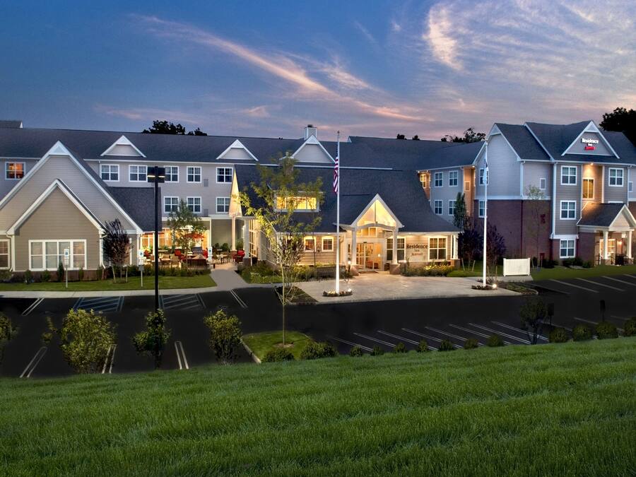A hotel with a central building, multiple wings, and a parking lot.