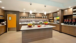 A modern kitchen with a central island, built-in shelves, and a coffee station. - Residence Inn Bridgewater Branchburg (Branchburg)