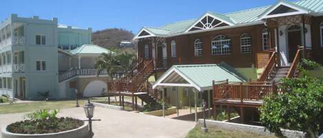 A hotel with a central courtyard, a covered seating area, and a staircase leading to the upper floors.