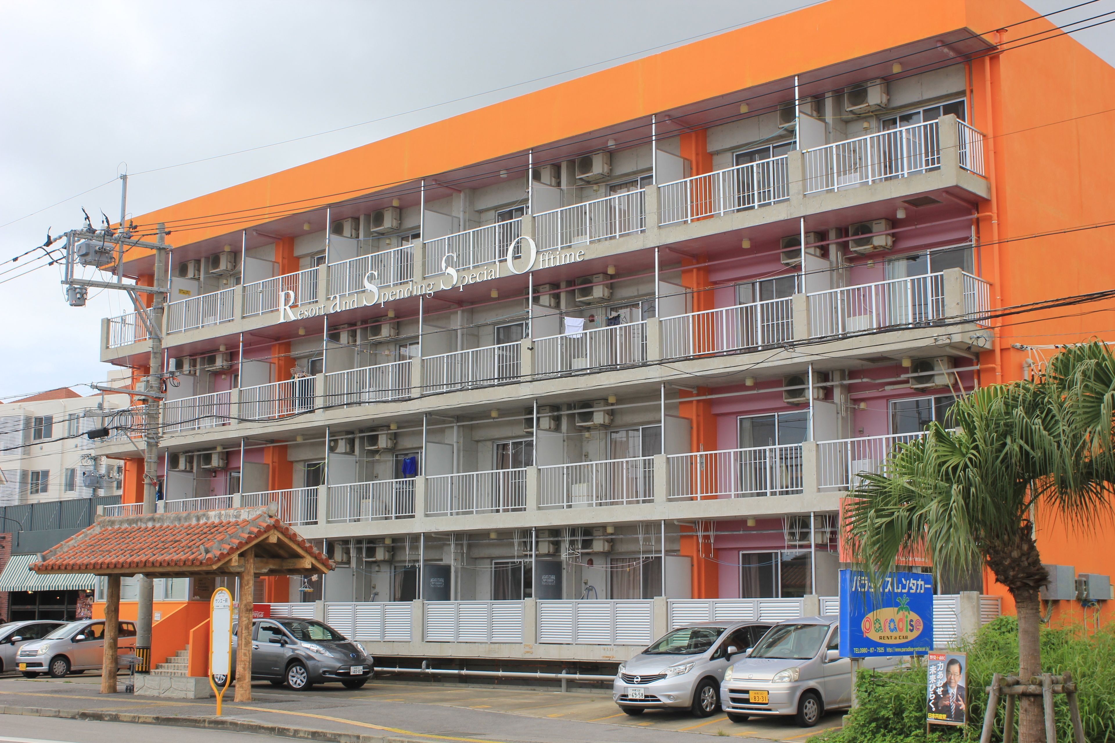 A multi-story hotel with balconies and a sign indicating it is a resort.