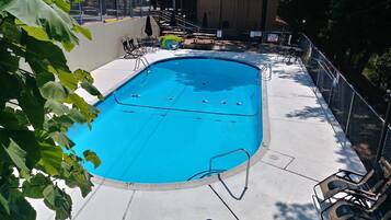 Seasonal outdoor pool, open 10:00 AM to 10:00 PM, pool umbrellas