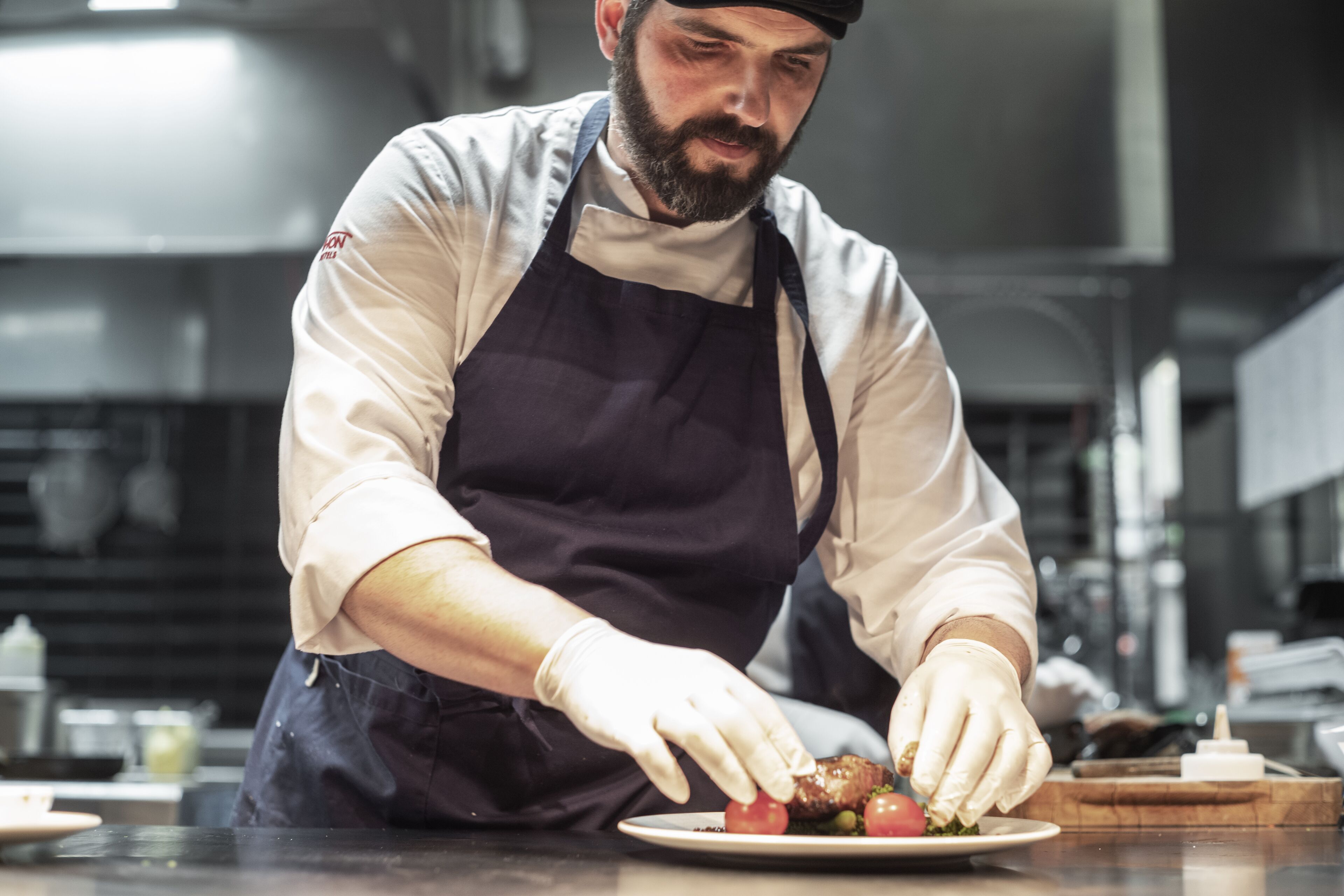A chef preparing food in a kitchen.