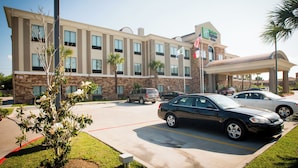 A hotel with a parking lot, multiple cars, and a clear sky. - Holiday Inn Express & Suites Houston NW/Beltway 8 West Road by IHG (Houston)