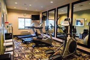 A hotel fitness center with treadmills, stationary bikes, and a mirrored wall. - Holiday Inn Express & Suites Houston NW/Beltway 8 West Road by IHG (Houston)