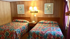 A hotel room with two beds, wooden panel walls, and two wall-mounted lamps. - Elmwood Motor Lodge (Boscawen)