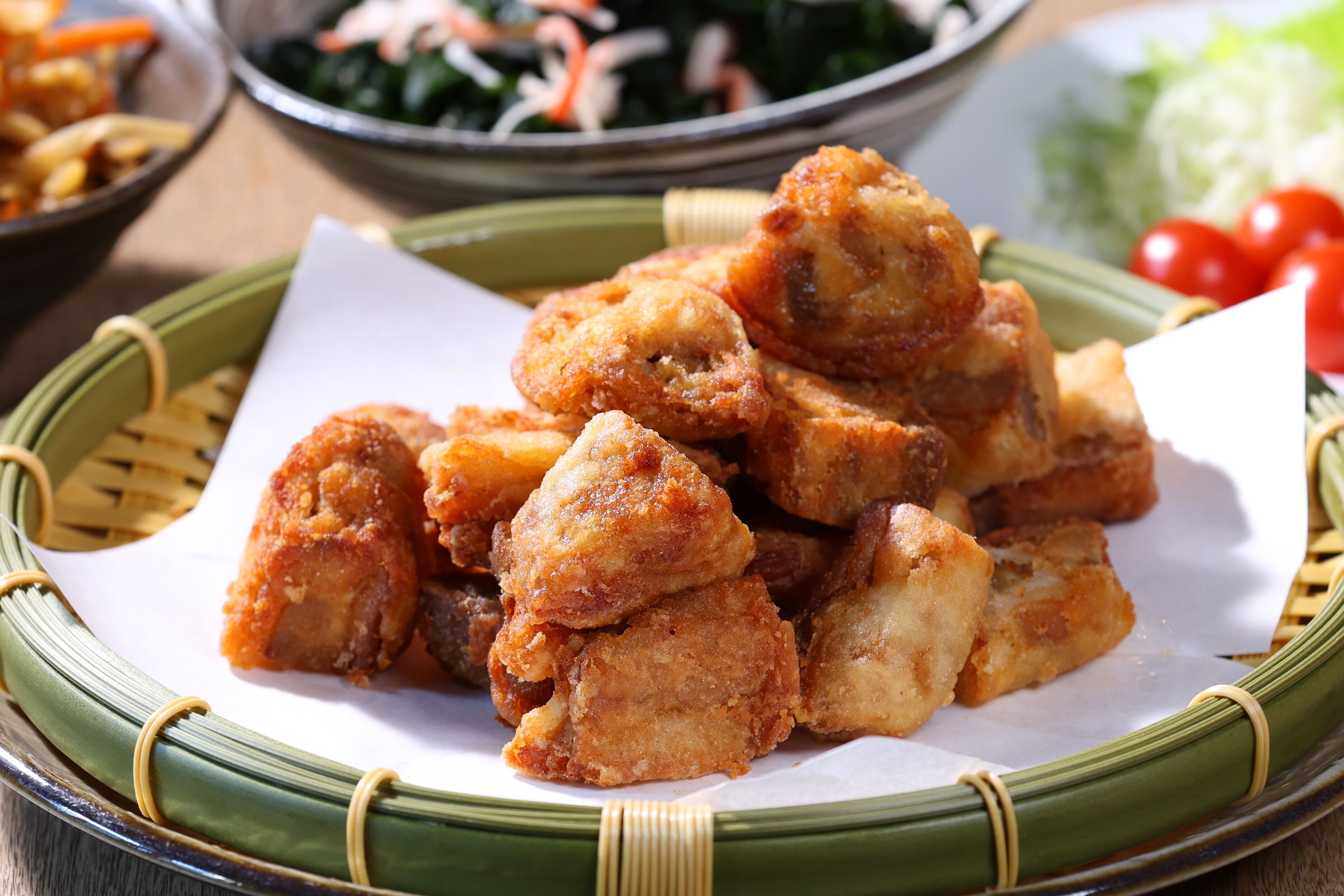 A basket of fried food items on a table.