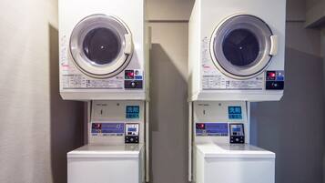 Two stacked front-loading washing machines with digital displays and control panels.