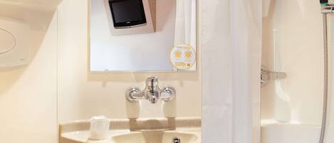 A modern bathroom with a sink, toilet, and shower.