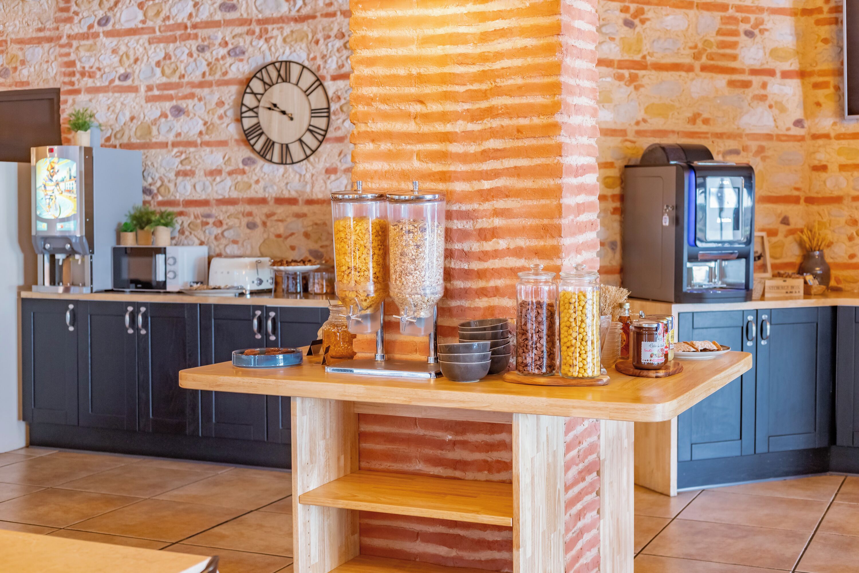 A kitchen area with a wooden counter, a clock, and various food containers.