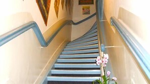 Una escalera con barandillas azules y un cartel de Islandia en la pared.