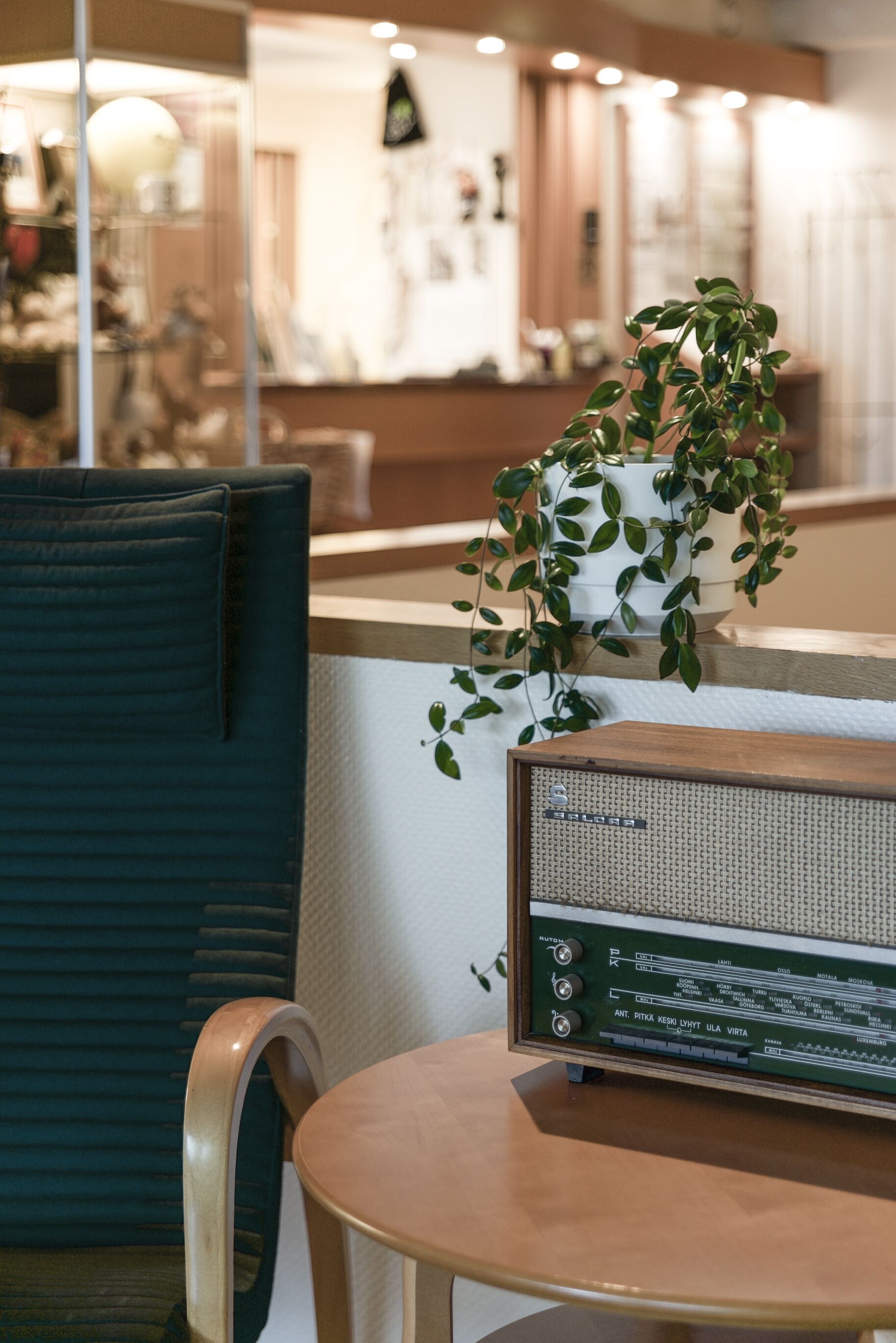 A room with a wooden table, a chair, and a radio.