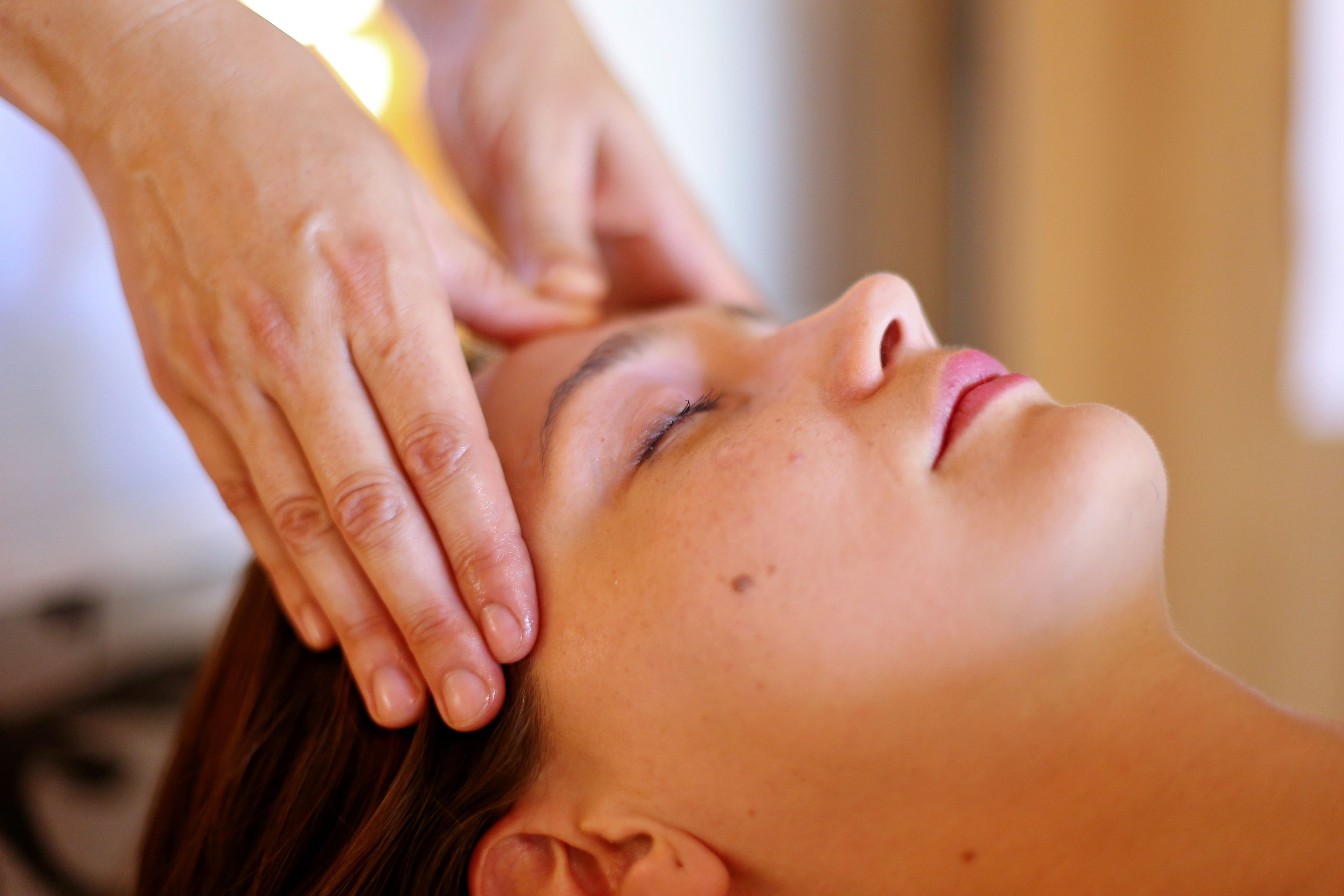 A person receiving a head massage.