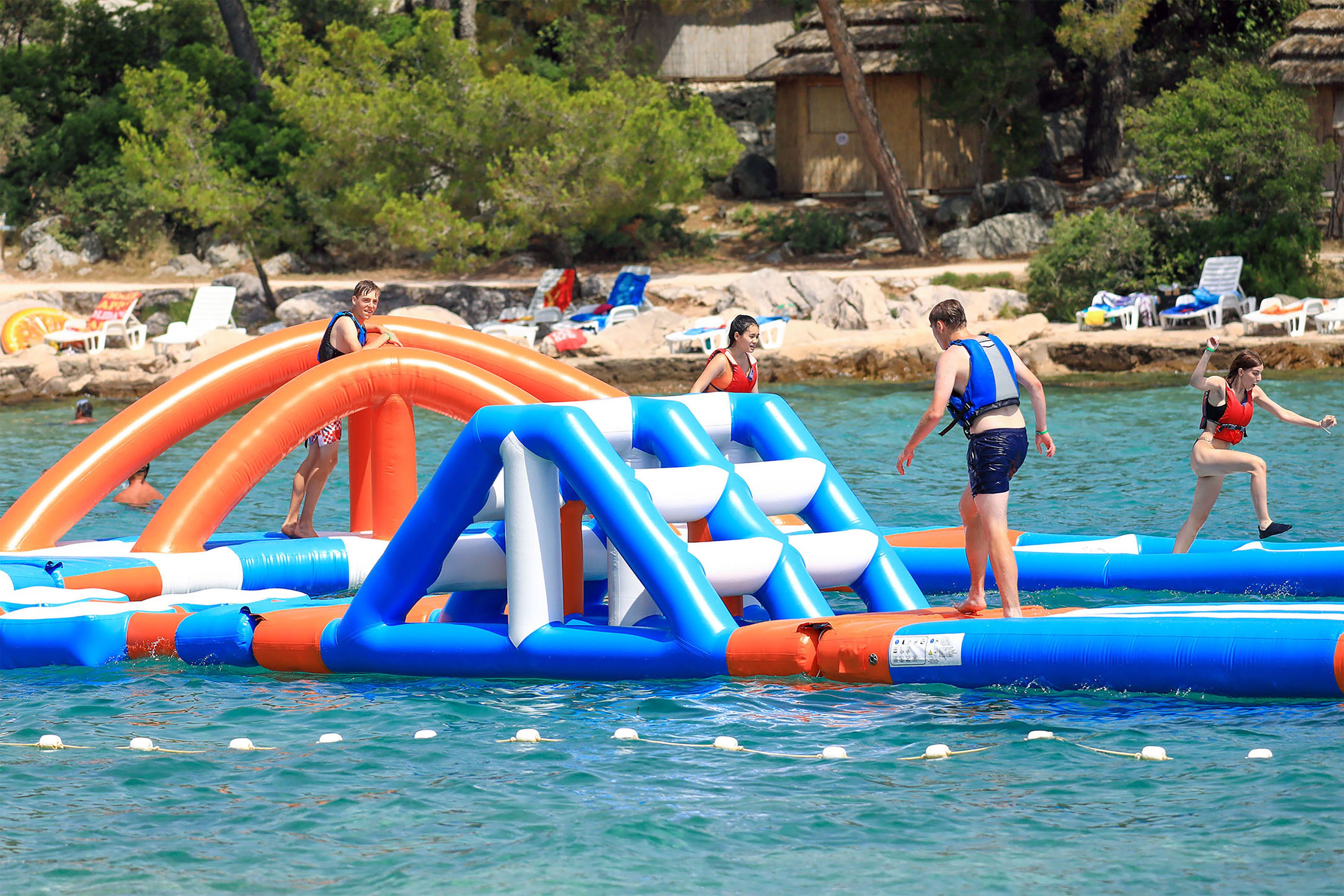 An inflatable pool with blue and orange colors, surrounded by water.